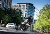 Three-quarter front angle of a person coming out of a turn on a motorcycle.