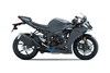 Profile angle of a gray motorcycle staged in a white studio background.