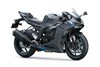 Three-quarter front angle of a gray motorcycle staged in a white studio background.