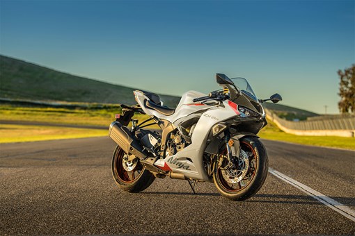 Three-quarter front angle of a parked motorcycle on a racetrack. opens in a new window