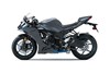 Side angle of a gray motorcycle staged in a white studio background.