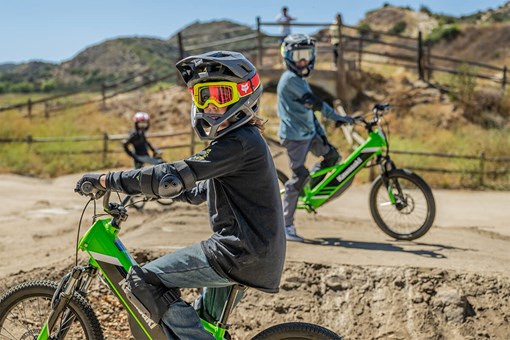 Side angle of two young adults sitting on electric balance bikes.  opens in a new window