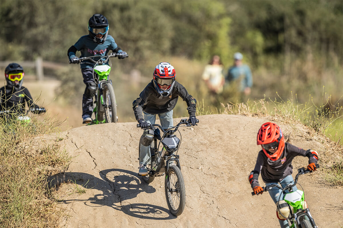 Front angle of multiple young adults riding electric balance bikes. 