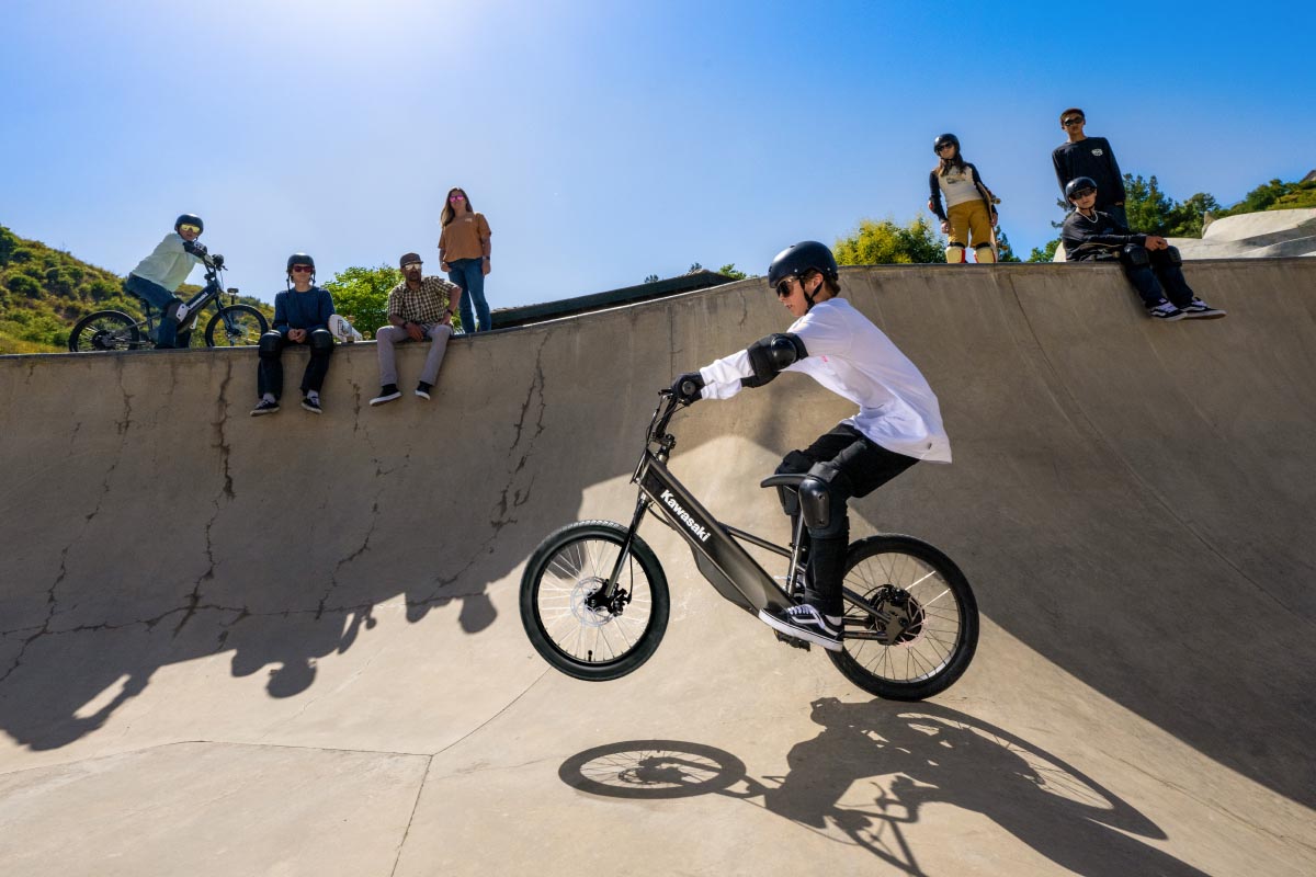 Upward side angle of a young adult riding an electric balance bike.