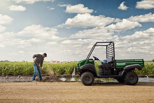 Side angle of an ATV parked on a dirt trail. opens in a new window