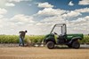 Side angle of an ATV parked on a dirt trail.
