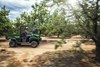 Side angle of a person riding an ATV off-road.