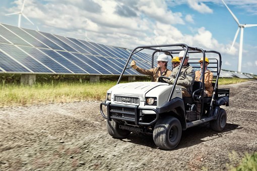 Three-quarter front angle of a person driving a side x side off-road. opens in a new window