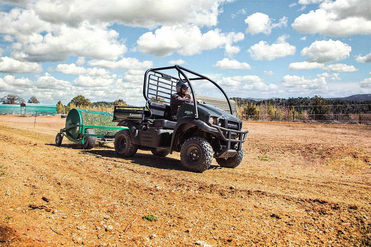 Three-quarter front angle of a person driving a side x side off-road.