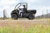 Side angle of a person driving a side x side off-road.