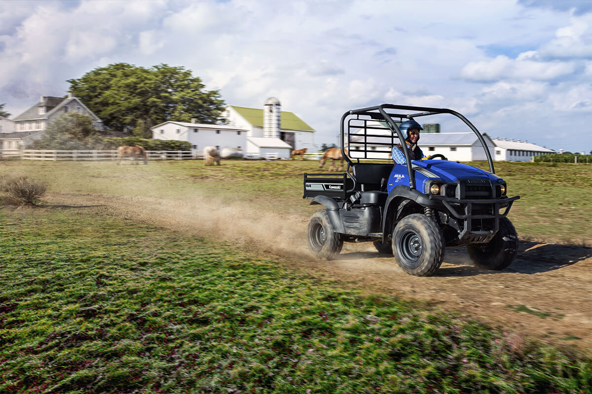 Three-quarter front angle of a person driving a side x side off-road.