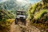 Front angle of a person driving a side x side off-road.