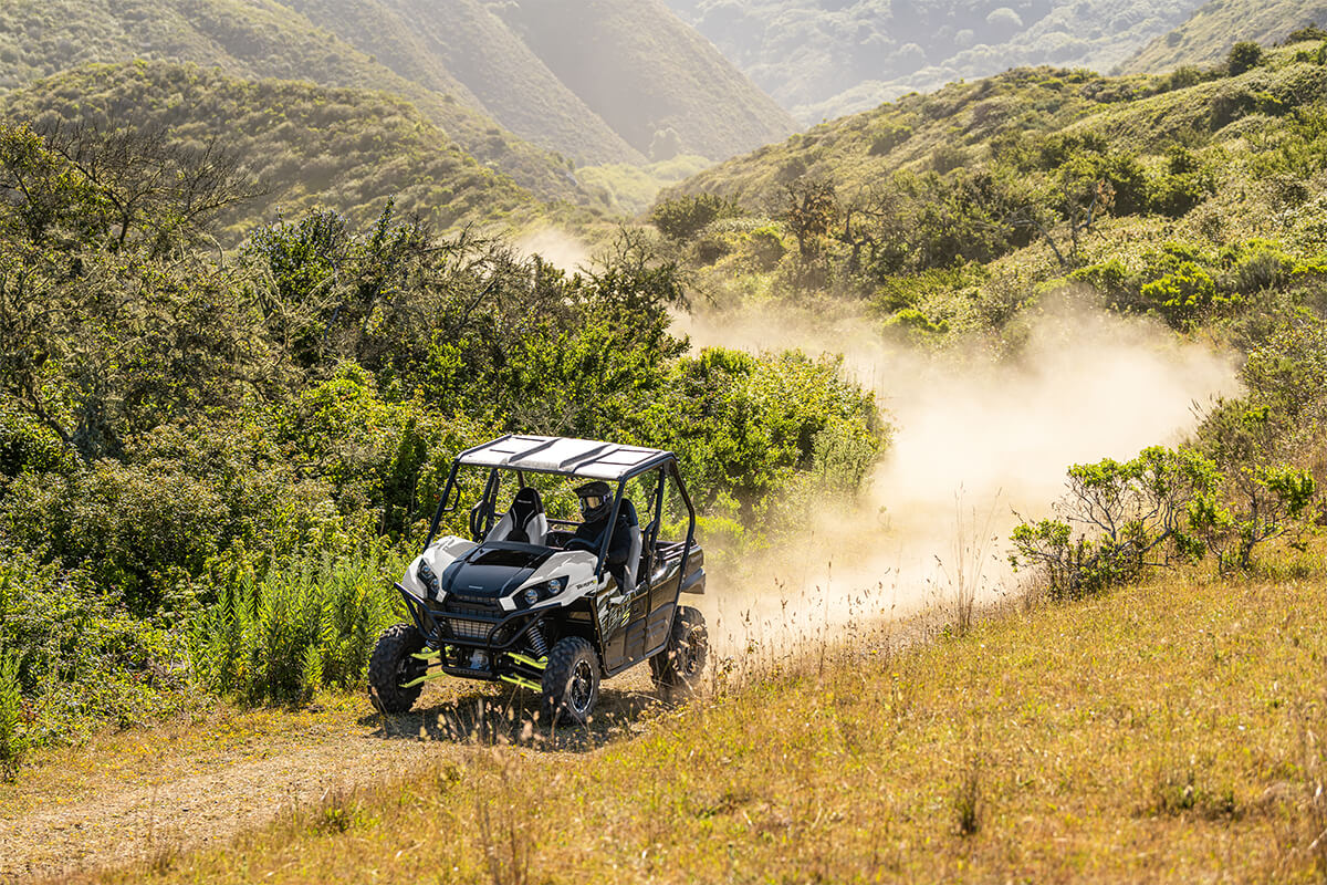 Three-quarter front angle of a person making a turn in a side x side off-road.