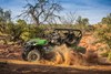 Side angle of a person driving a side x side off-road.