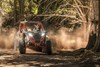 Front angle of a person driving a side x side off-road.
