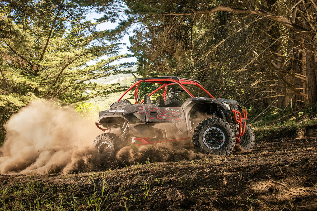 Side angle of a person driving a side x side off-road.