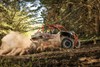 Side angle of a person driving a side x side off-road.