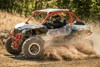 Three-quarter front angle of a person making a sharp turn in a side x side off-road.