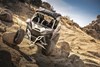 Front angle of a person driving a side x side off-road.