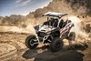 Three-quarter front angle of a person making a sharp turn in a side x side off-road.