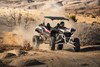 Three-quarter front angle of a person coming out of a turn in a side x side off-road.