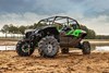 Three-quarter front angle of a side x side parked off-road.