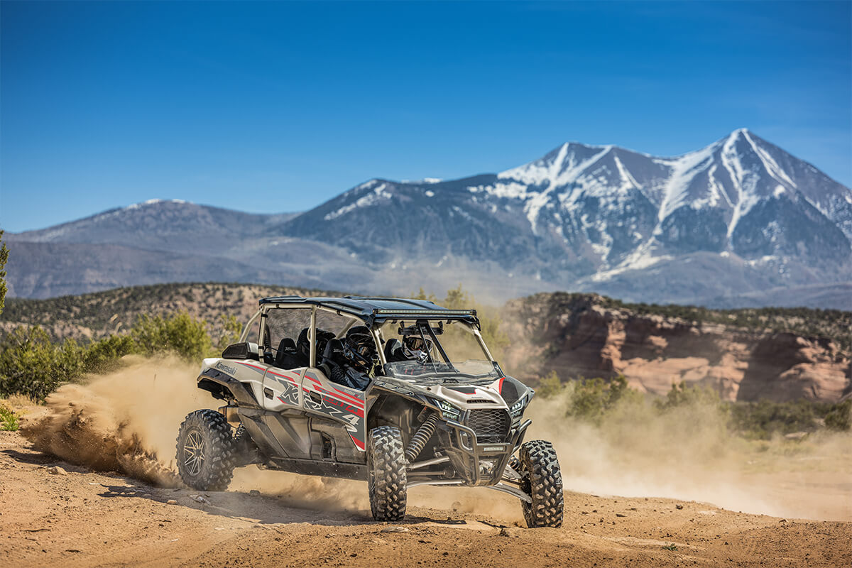 Three-quarter front angle of a person making a sharp turn in a side x side off-road.