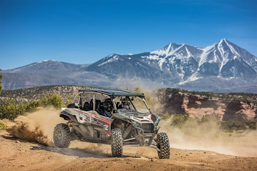 Three-quarter front angle of a person making a sharp turn in a side x side off-road. opens in a new window