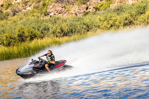 Three-quarter front angle of a person making a turn on a personal watercraft on the water. opens in a new window