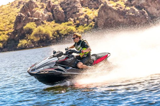 Three-quarter front angle of a person on a personal watercraft on the water. opens in a new window