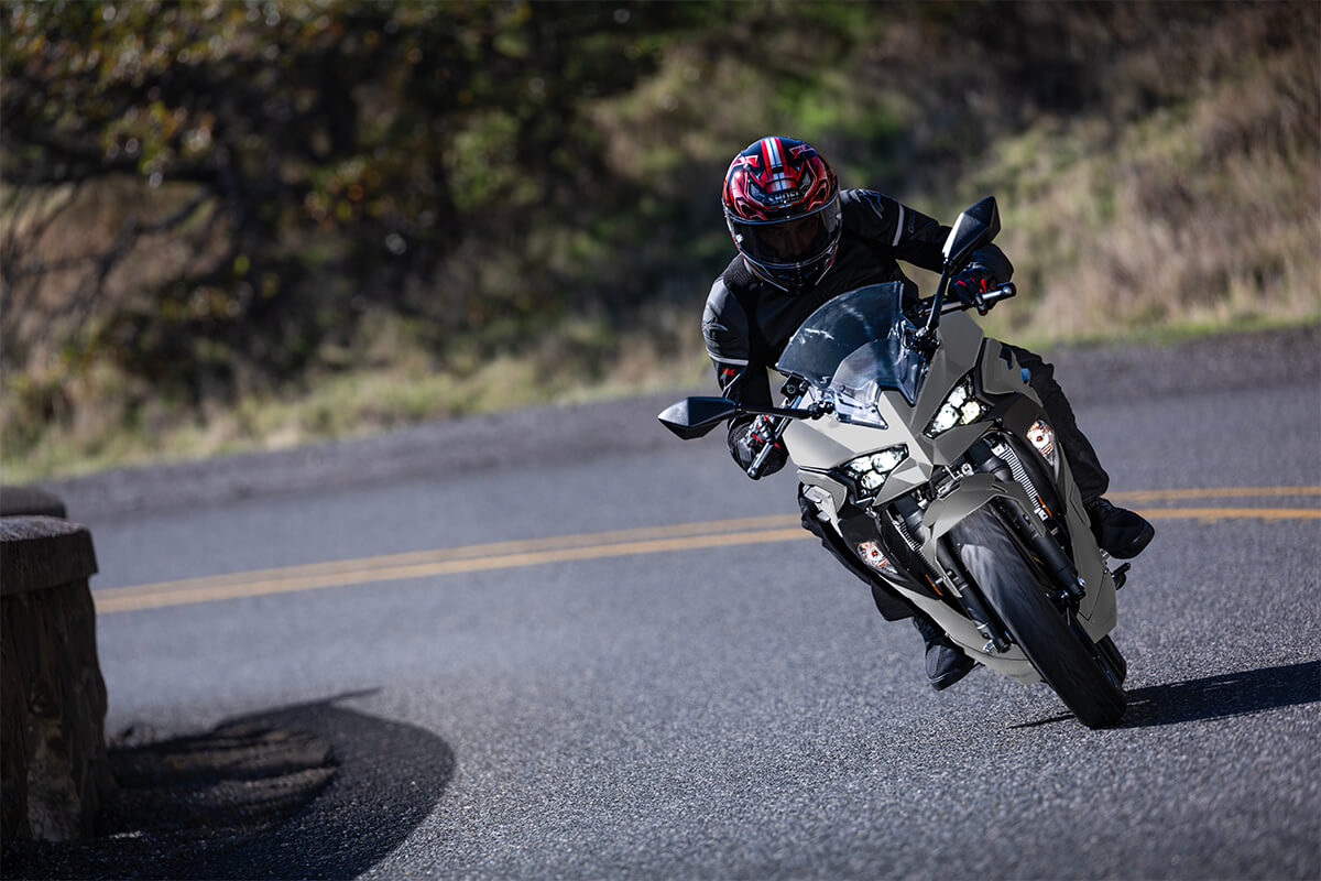 Front angle of a person riding a motorcycle on a highway.