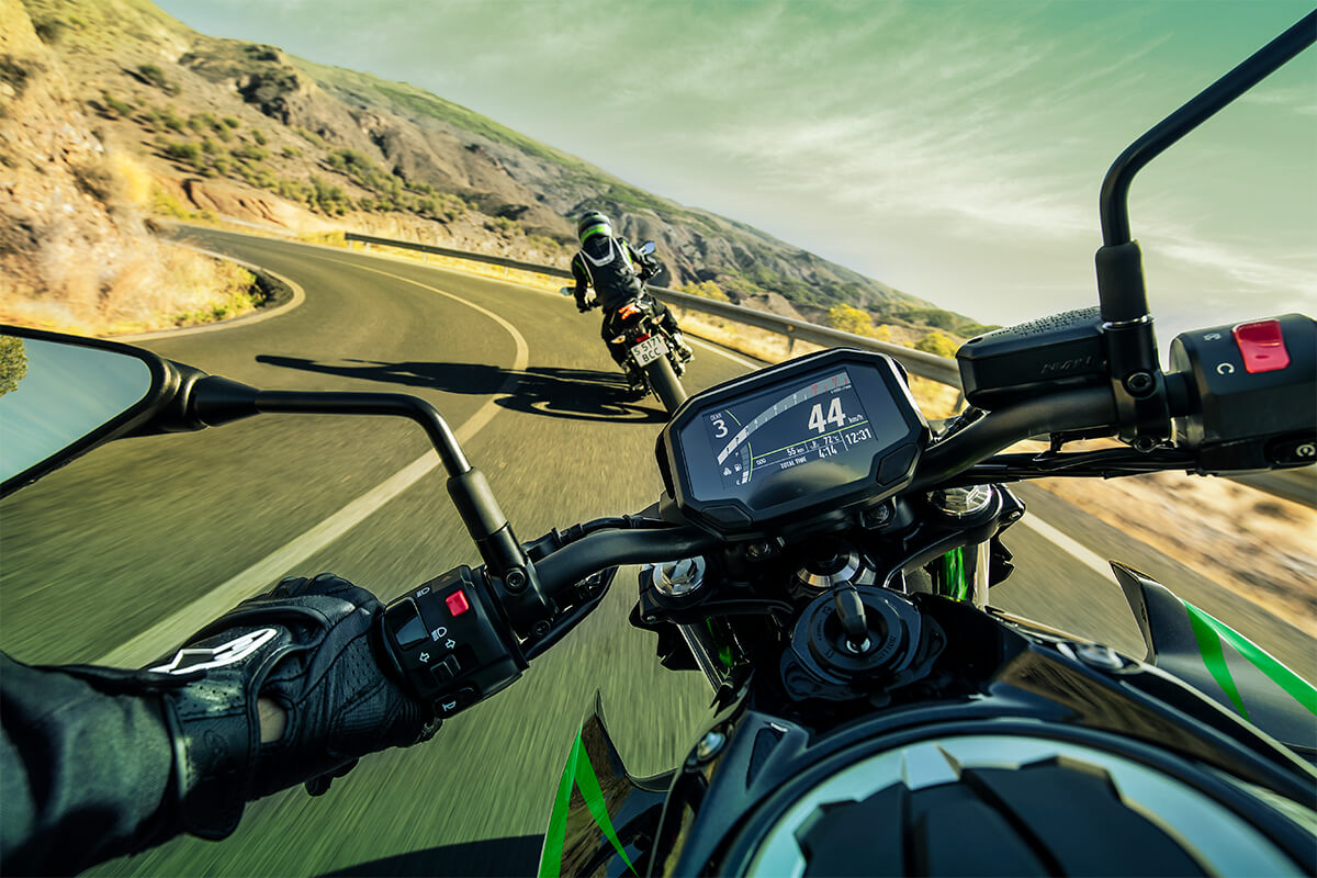 POV angle of a person riding a motorcycle on a highway.