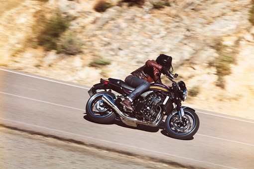 Side angle of a person riding a motorcycle on a highway. opens in a new window