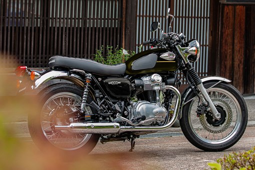 Side angle of a person riding a motorcycle on a highway. opens in a new window