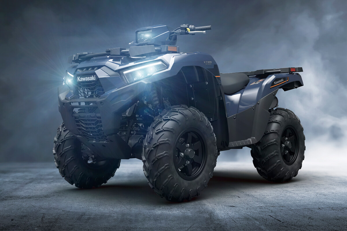 Front three-quarter view of an ATV staged in a dark steamy studio background.