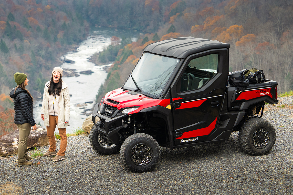 Front three-quarter view of a side x side parked overlooking a canyon.