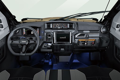 Interior cabin view of the front dash and controls of a side x side with floor accent lighting. opens in a new window