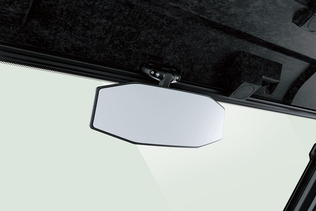 Close-up view of the rearview mirror of a side x side staged in a white studio background.