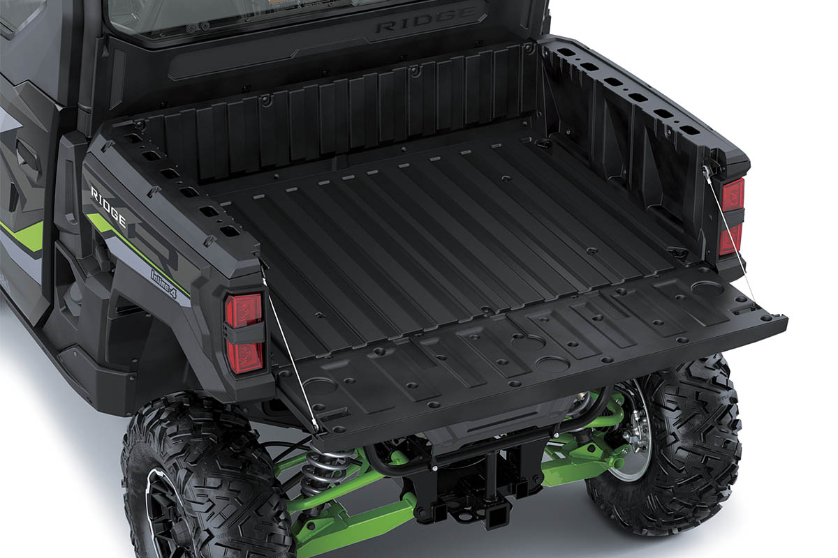 Rear view of the cargo bed of a side x side staged in a white studio background.