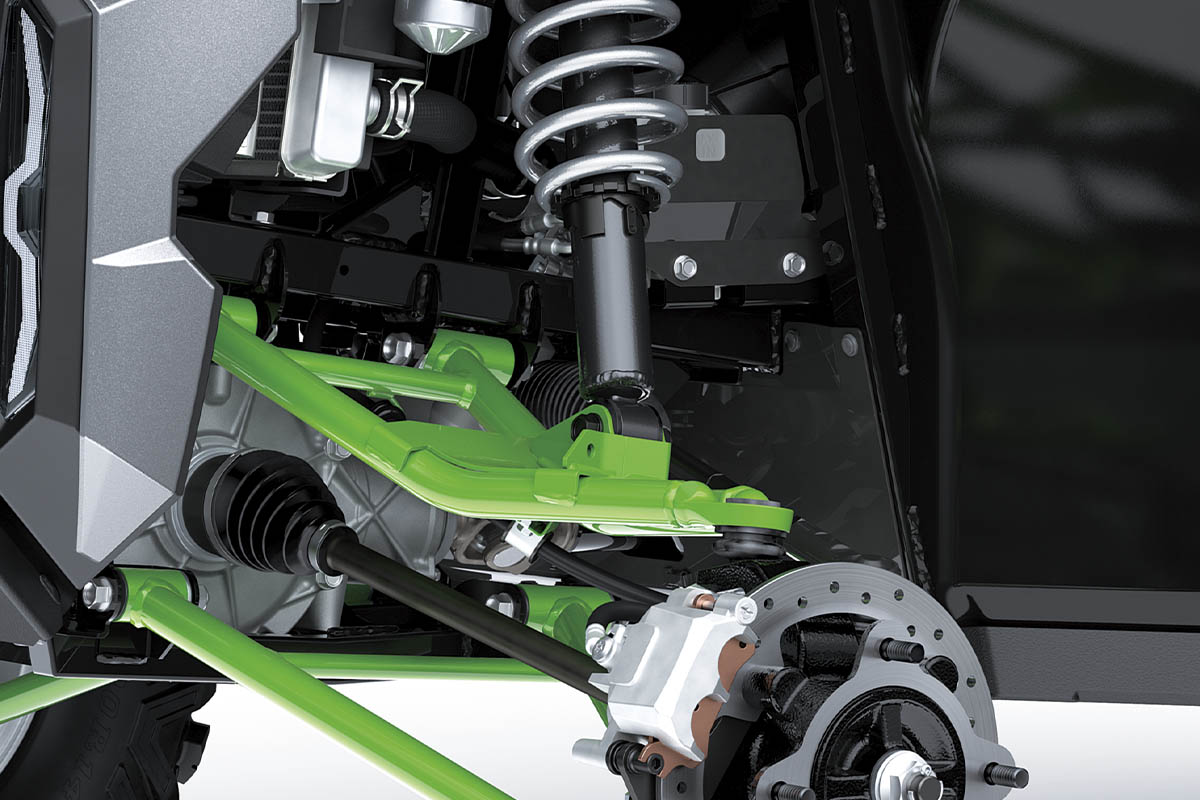 Close-up view of the shock and A-arm of a side x side staged in a white studio background.