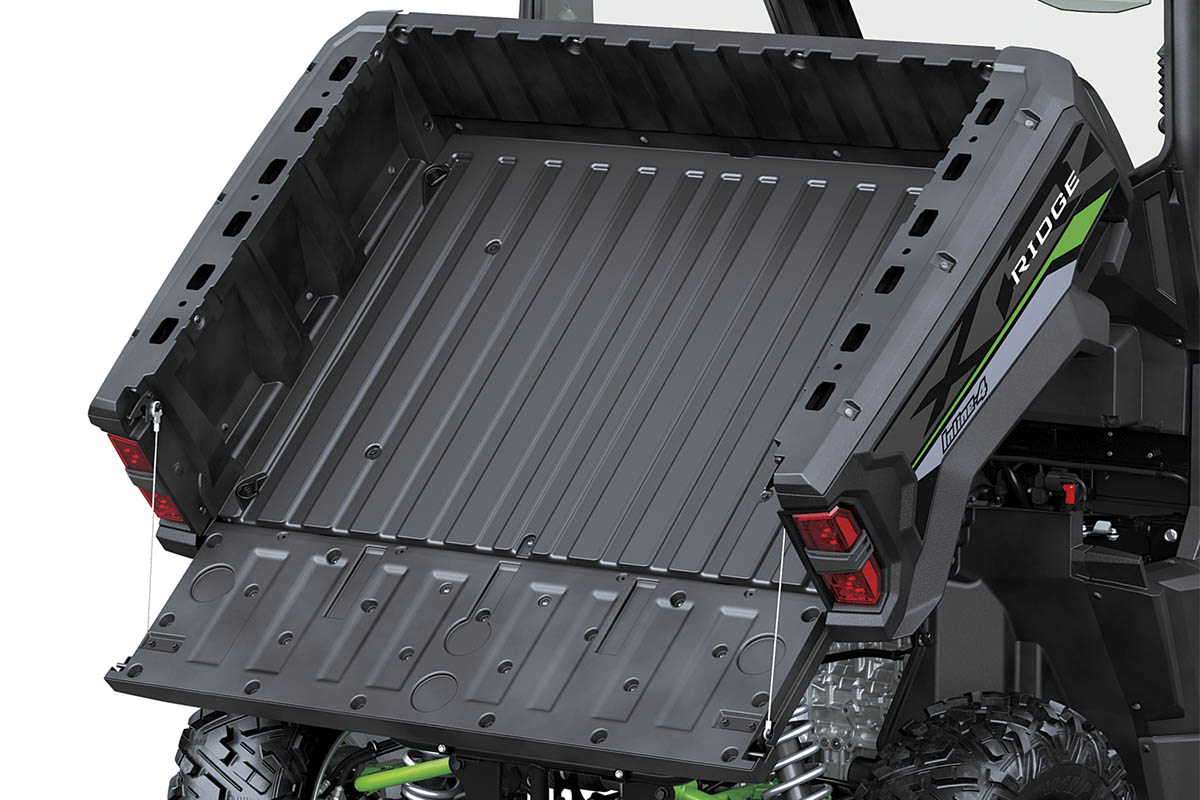 Front angle of the raised cargo bed of a side x side staged in a white studio background.