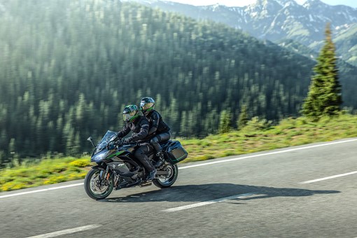 Side angle of a person riding a motorcycle on a highway. opens in a new window