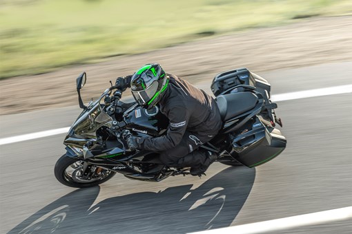 Overhead angle of a person riding a motorcycle on a highway. opens in a new window
