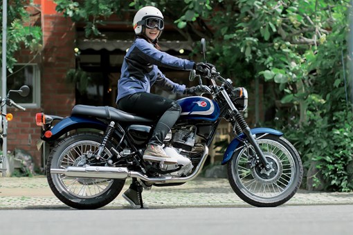 Side angle of a person seated on a motorcycle. opens in a new window