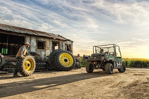Three-quarter rear angle of a person driving a side x side off-road. opens in a new window