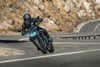 Front angle of a person riding a motorcycle in the mountains.