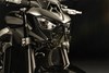 Closeup view of motorcycle headlights in a dark studio.