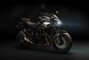 Profile angle of a motorcycle staged in a dark studio.