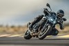 Three-quarter front angle of a person riding a motorcycle on a track.