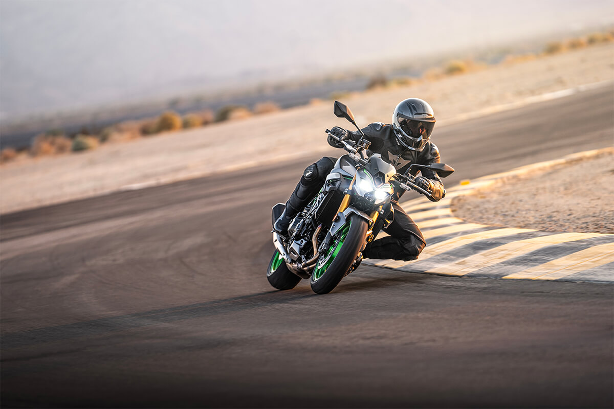 Front angle of a person cornering on a motorcycle on the track.